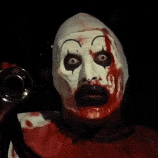 a close up of a clown 's face with blood dripping from it