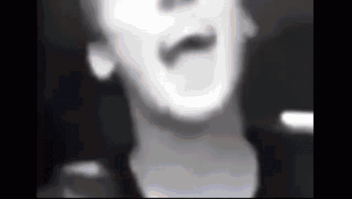 a black and white photo of a man 's face .
