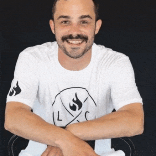 a man wearing a white t-shirt with a flame on it