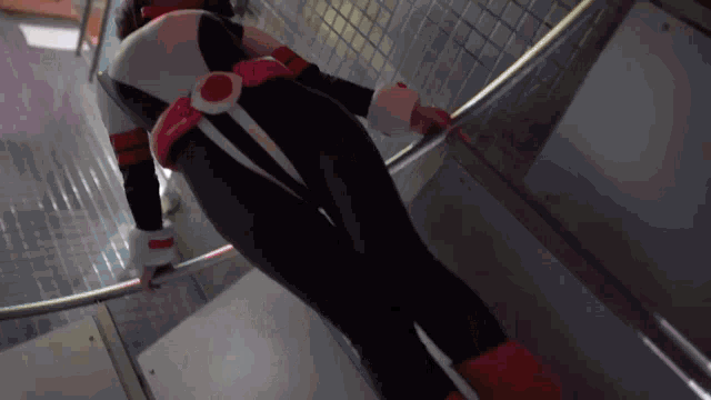 a person in a superhero costume climbs stairs
