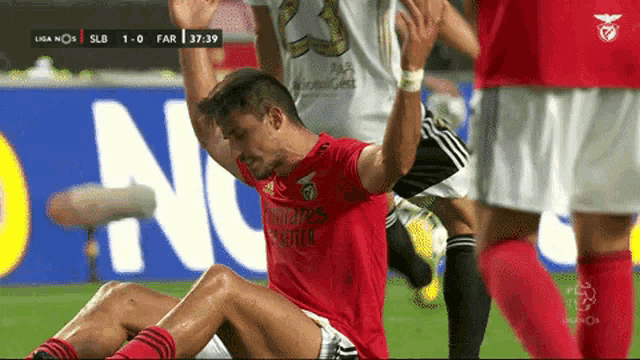 a man in a red shirt that says fly emirates