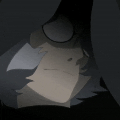 a close up of a person 's face with a black hood