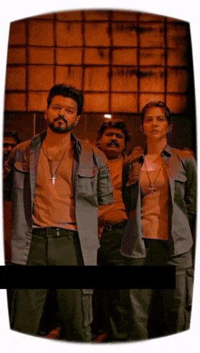 a man with a cross necklace stands next to a woman with a cross necklace