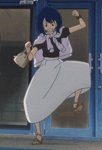 a woman in a white skirt is standing in front of a door with her fist in the air