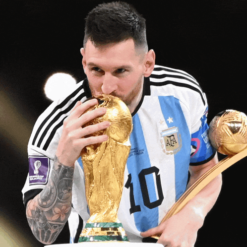 a soccer player with the number 10 on his jersey holds a trophy