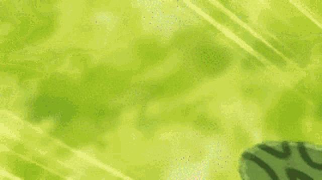 a close up of a green leaf with a leopard print on it