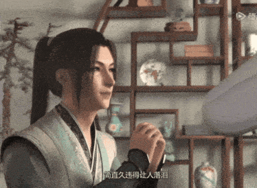 a man in a ponytail is standing in front of a bookshelf