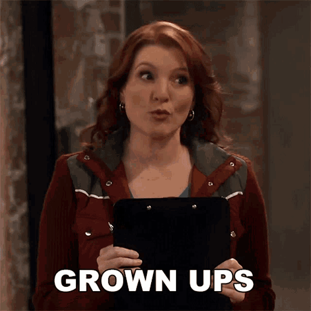 a woman holding a clipboard with the words grown ups on it