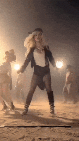 a woman in a pirate costume is dancing in the desert