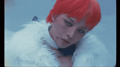 a woman with red hair is wearing a fur coat