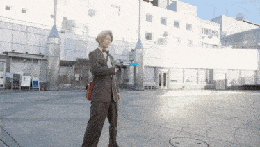a man in a suit is holding a blue object in front of a white building