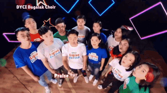 a group of people wearing t-shirts that say praise are standing together