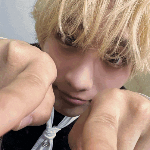 a close up of a person 's face with their hands