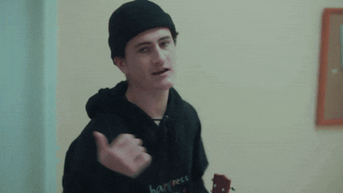 a young man wearing a black happiness hoodie