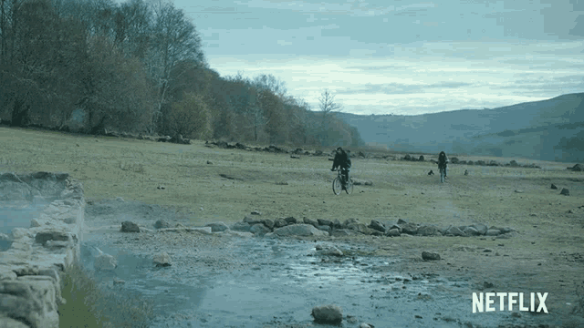 a person riding a bike in a field with a netflix logo in the corner