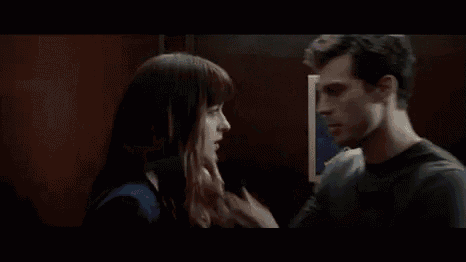 a man and a woman are kissing in front of a poster that says jazz .