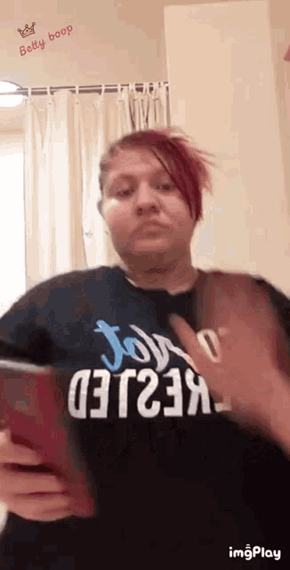 a woman with red hair is taking a picture of herself in a bathroom .