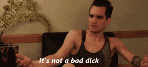 a man in a tank top says it 's not a bad dick while sitting at a table