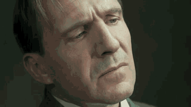 a close up of a man 's face with a serious expression