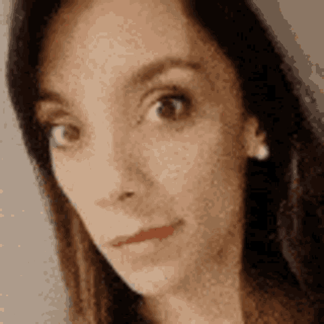 a close up of a woman 's face with a blurry background .