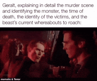 two men are talking to each other in a dark room
