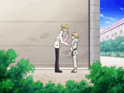 a man holding a pink bunny puppet stands next to another man