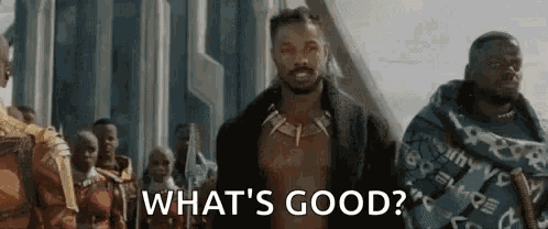 a man is standing in front of a group of people and says `` what 's good '' .