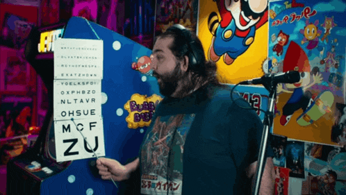 a man wearing headphones holds a sign that says mcf zu