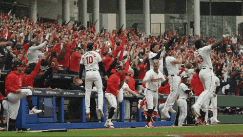 a baseball player with the number 10 on his jersey jumps in the air