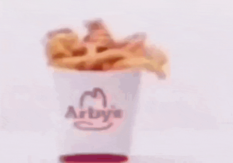 a blurry picture of a hamburger with a man 's face behind it .