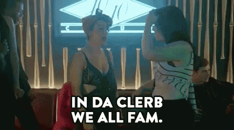 a group of women are dancing in a club and one of them is saying `` in da clerb we all fam '' .