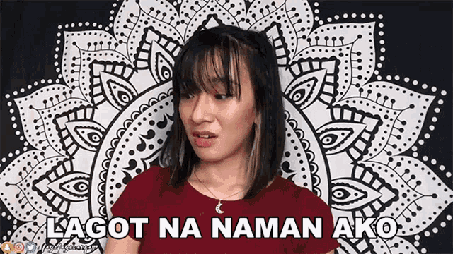 a woman in a red shirt is standing in front of a wall with a floral pattern and says " lagot na naman ako "
