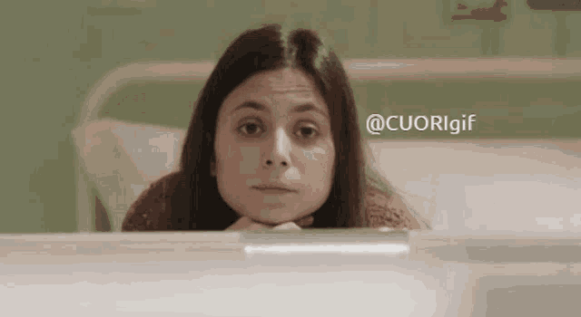 a woman in a hospital bed with the hashtag @cuorigif above her head