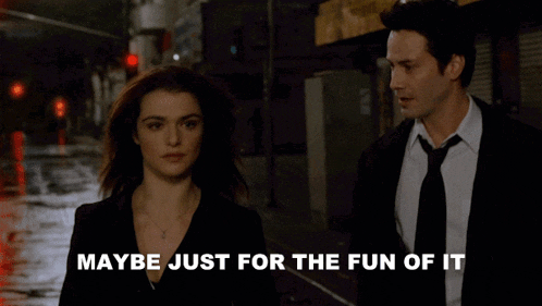 a man and a woman are walking down a street with maybe just for the fun of it written on the bottom