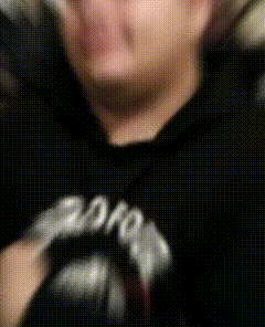 a blurry picture of a person wearing a black shirt that says ' 2012 ' on it