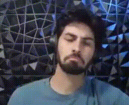 a man with a beard is wearing headphones and looking at the camera