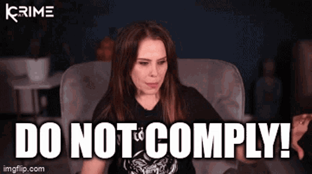 a woman is sitting in a chair with the words do not comply behind her .