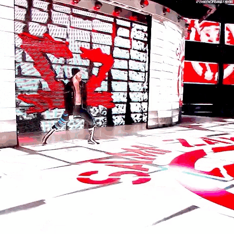 a man is walking on a stage in front of a large screen that says ' ethenewlongstrikes '