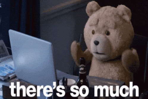 a teddy bear sitting in front of a laptop with the words there 's so much above him