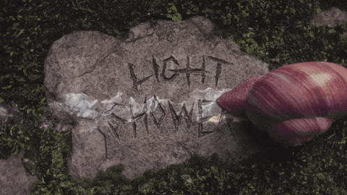 a large rock has the word light shower written on it