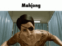 a man with a tattoo on his chest is standing in a bathroom with the word mahjong above him