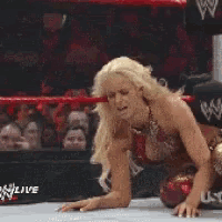 a woman is in a wrestling ring with the word live on the bottom