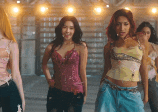 a group of women are dancing in a room