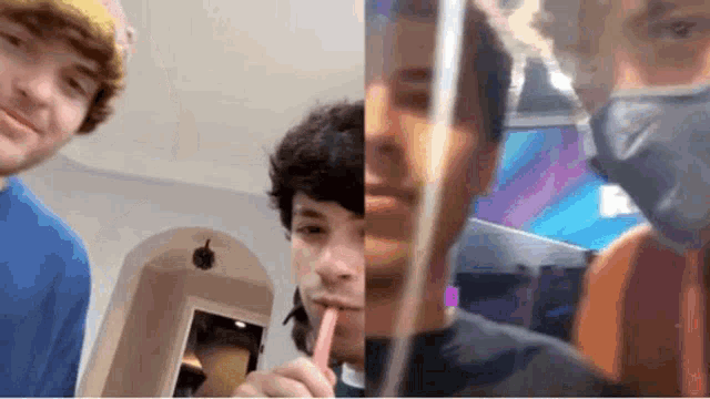 a group of young men are standing next to each other and one of them is holding a straw in his mouth .