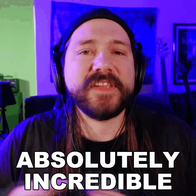a man with long hair and a beard is wearing headphones and saying absolutely incredible
