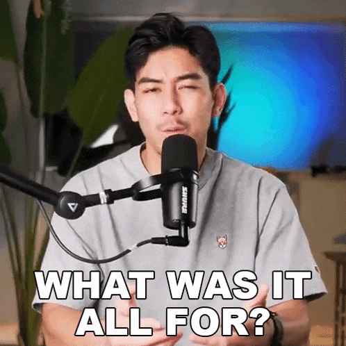 a man is standing in front of a microphone and asking what was it all for