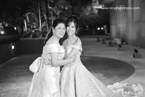 a black and white photo of two women with the website niceprintphoto.com in the corner