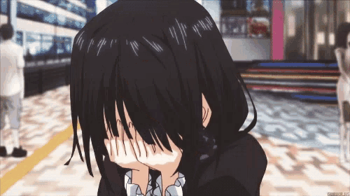 a girl with black hair is covering her face with her hands in a scene from an anime