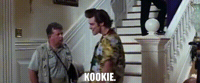 two men are standing next to each other on a set of stairs and one of them is saying kookie .