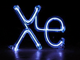 a neon sign that says xe on a dark background .